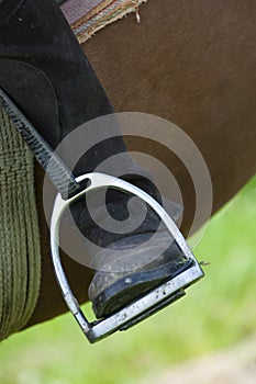 Dressage rider and horse closeup boot in stirrup detail