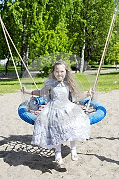 Dressed like princess girl on a swing