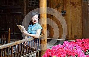 Dressed in traditional Chinese costume woman was reading a book