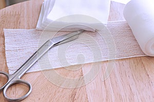 Dressing or clean wound tools includes Roll gauze,pile of gauzes and gauze roll cutter or scissors