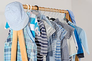 Dressing closet with clothes arranged on hangers.