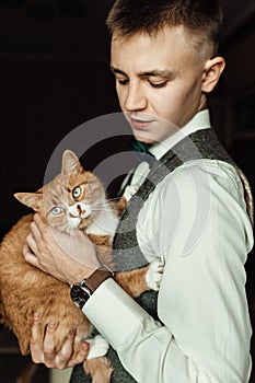 Dressing groom and preparing for ceremony on background