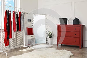 Dressing room with clothes, shoes and accessories. Elegant interior design
