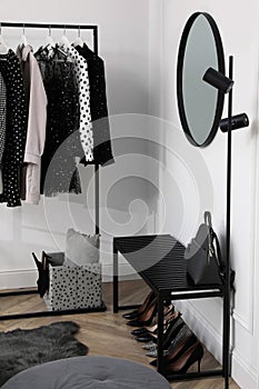 Dressing room with clothes, shoes and accessories. Elegant interior design