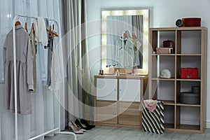 Dressing room interior with makeup mirror, wardrobe rack