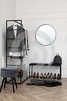 Dressing room with stylish clothes, shoes and accessories. Elegant interior design