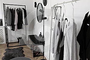 Dressing room with stylish clothes, shoes and accessories. Elegant interior design