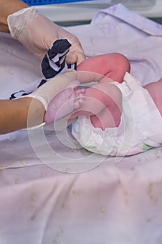 Dressing sock a newborn baby by a doctor immediately after delivery