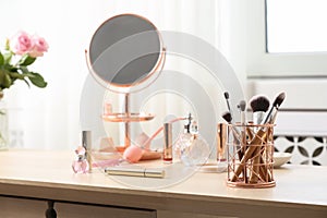 Dressing table with different makeup products and accessories