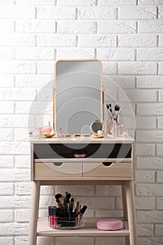 Dressing table with different makeup products and accessories