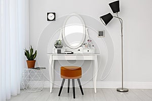 Dressing table with mirror in room interior