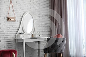 Dressing table with mirror in room interior