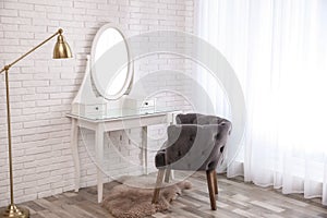 Dressing table with mirror in room interior