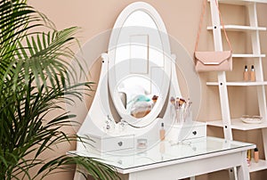 Dressing table with mirror in room interior