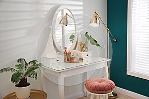 Dressing table with mirror in room interior