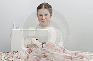 Dressmaker woman working with sewing machine.