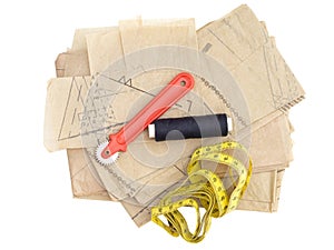 Dressmaking, sewing equipment isolated on white. Paper pattern thread, marker etc. photo