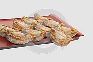 Dried abalone on bamboo tray in white background