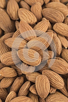 Dried almond seeds in bulk, close-up, top view. Texture