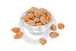 Dried almonds on glass bowl isolated on a white background