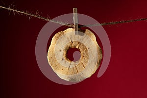 Dried apple slice on a rope on a clothespin.