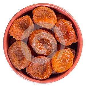 Dried apricots in brown cup isolated on white