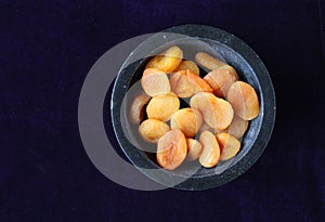 Dried apricots flat lay dark background