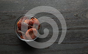 Dried apricots on a wood background