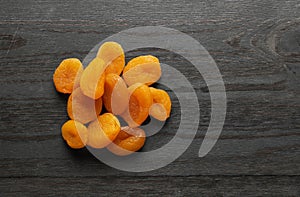 Dried apricots on a wood background