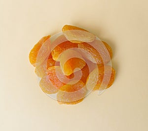Dried apricots on a yellow background.