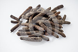 dried aromatic pippali long pepper on a white background