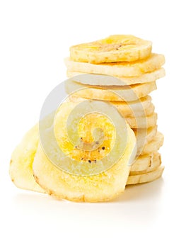 Dried banana chips snack stacked over white