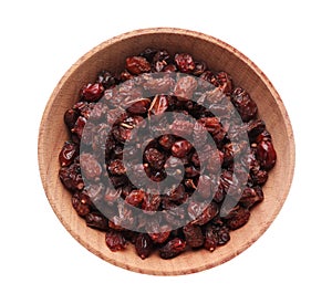 Dried barberries in wooden bowl isolated on white, top view