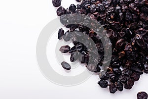 Dried barberry berries on the rustic background