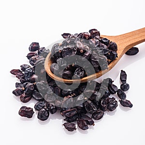 Dried barberry berries on the rustic background