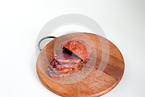 Dried beef. Sliced beef jerky. Meat on a wooden board.