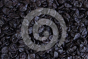 Dried black plum top view food background