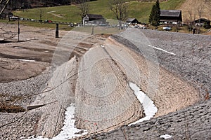 Dried bottom tiled with stones with patches of snow of KlÃÂ¶ntalersee lake photo