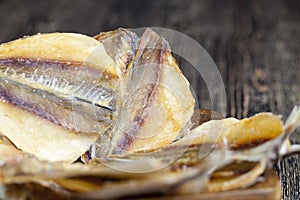 dried and butchered small fish on a wooden table