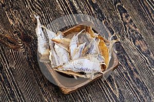 dried and butchered small fish on a wooden table