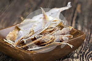 dried and butchered small fish on a wooden table