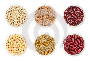 Dried and canned chickpeas, brown lentils and red kidney beans, in white bowls