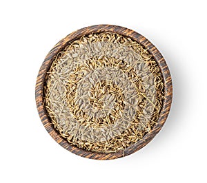 Dried caraway seeds in wood bowl on white background. top view