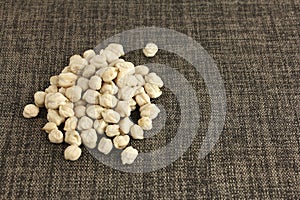 Dried chickpeas on cloth, vegetable protein and ingredient for hummus, copy space