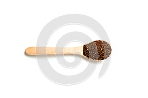 A dried chili flakes in a wooden spoon