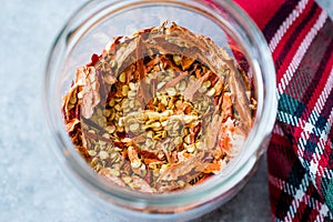 Dried Chili Pepper Flakes and Seeds in Glass Bowl