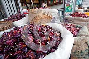 Dried chili in sacks in outdoor market