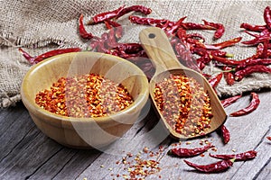 Dried chilies with chili powder, pepper, and red paprika in a wooden bowl Spicy seasoning Healthy food, top view