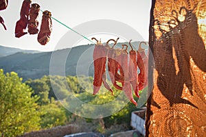 Dried chilies hanging on a rope in a village in susnset, photo