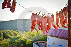Dried chilies hanging on a rope in a village in susnset,